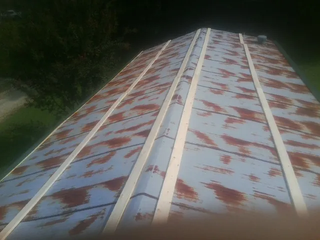Rusted metal roof panels with new wood purlins before replacement — Storm Damage Roof Repair in Allegan by Roofing Brothers